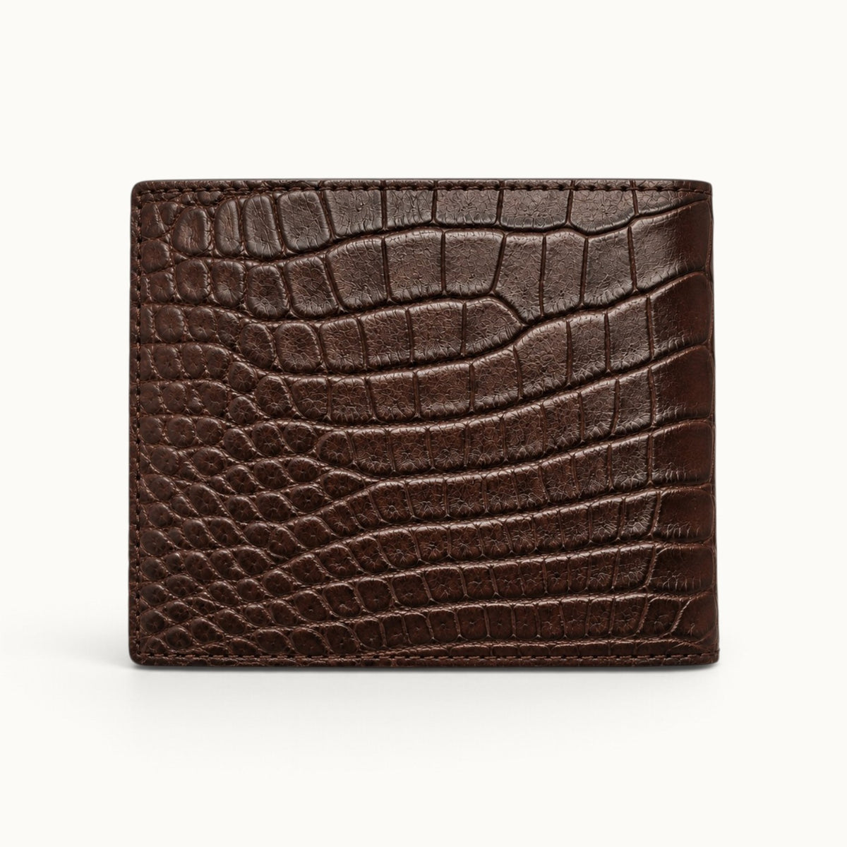 Back view of The Ashford brown crocodile bifold wallet showcasing the natural Siamese crocodile scale pattern, rich chocolate-brown finish, and precise edge stitching.
