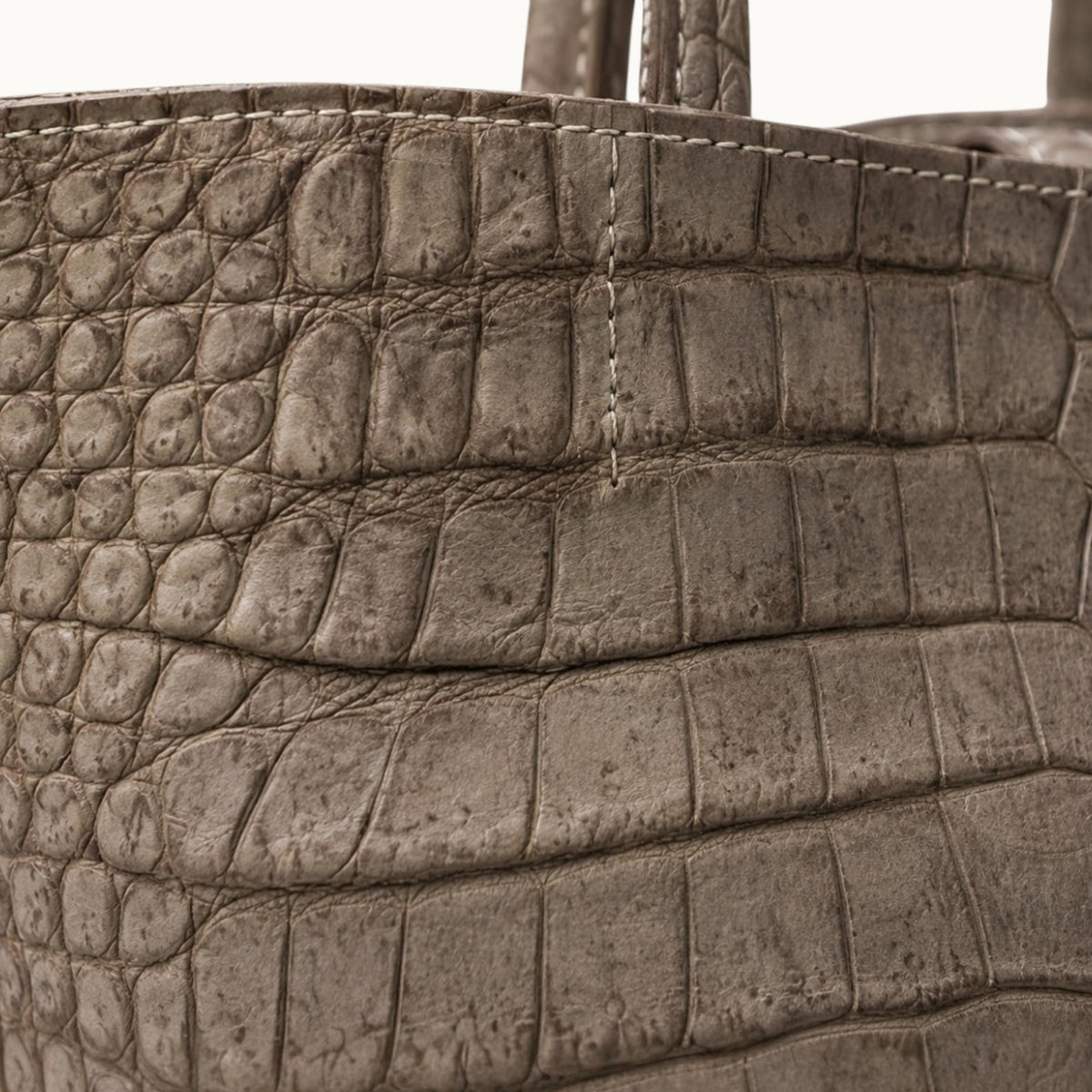 Close-up of genuine Porosus crocodile leather on The Atelier Tote, highlighting the distinctive natural scale pattern and exceptional craftsmanship.