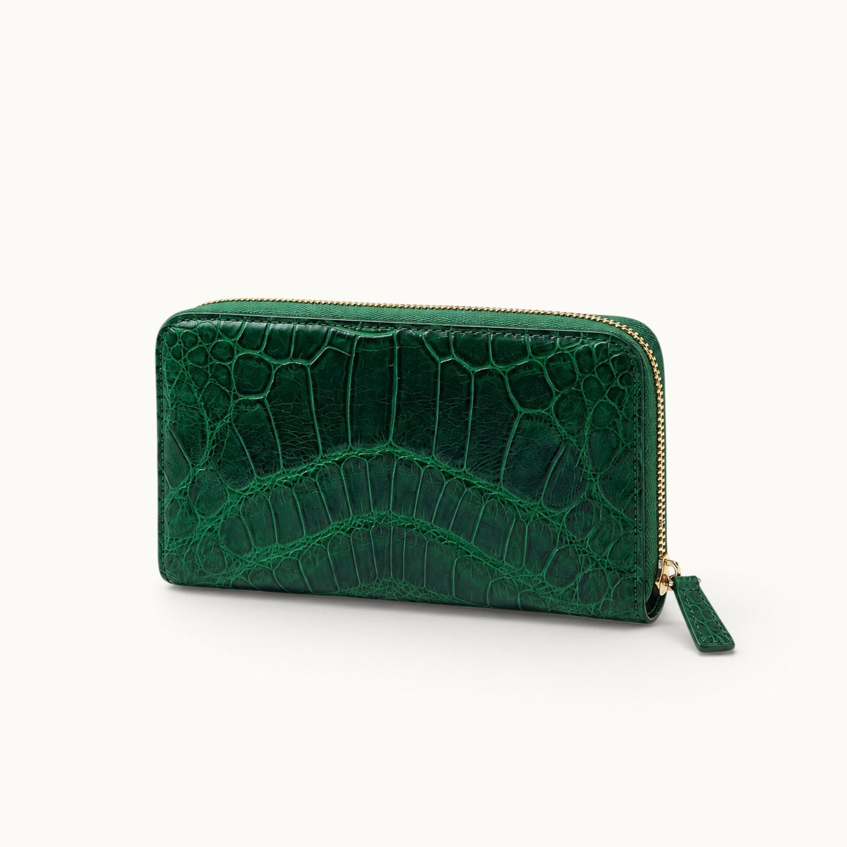 Angled view of the Belvedere Siamese crocodile zip-around wallet in Emerald Green with natural scale pattern and gold-tone hardware