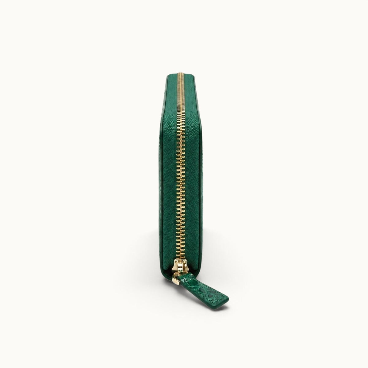 Side view of the Belvedere Siamese crocodile zip-around wallet in Emerald Green showing its slim profile and zip-around closure