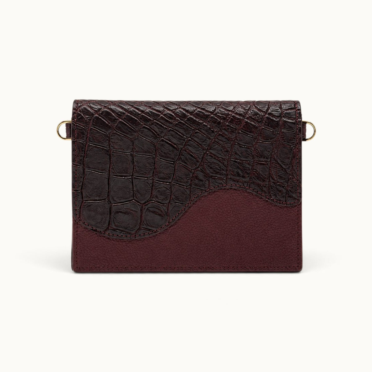 Front view of The Berkeley Crocodile Convertible Wallet in Bordeaux with no straps attached.