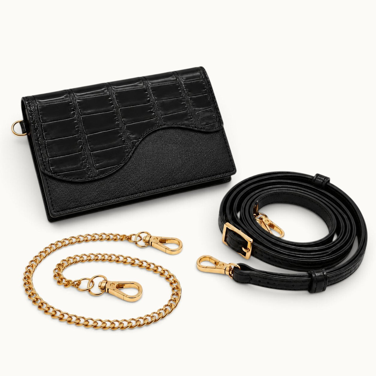 The Berkeley Crocodile Convertible Wallet in Black with removable gold-tone chain and adjustable crocodile leather shoulder strap.