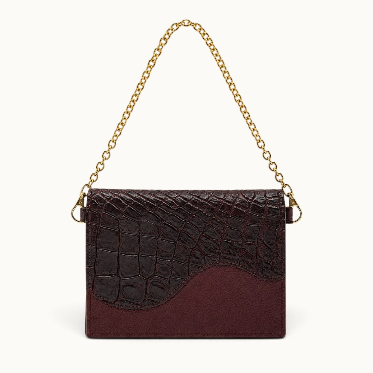 The Berkeley Crocodile Convertible Wallet in Bordeaux with genuine Siamese crocodile leather, pebbled calf leather, and removable gold-tone chain.