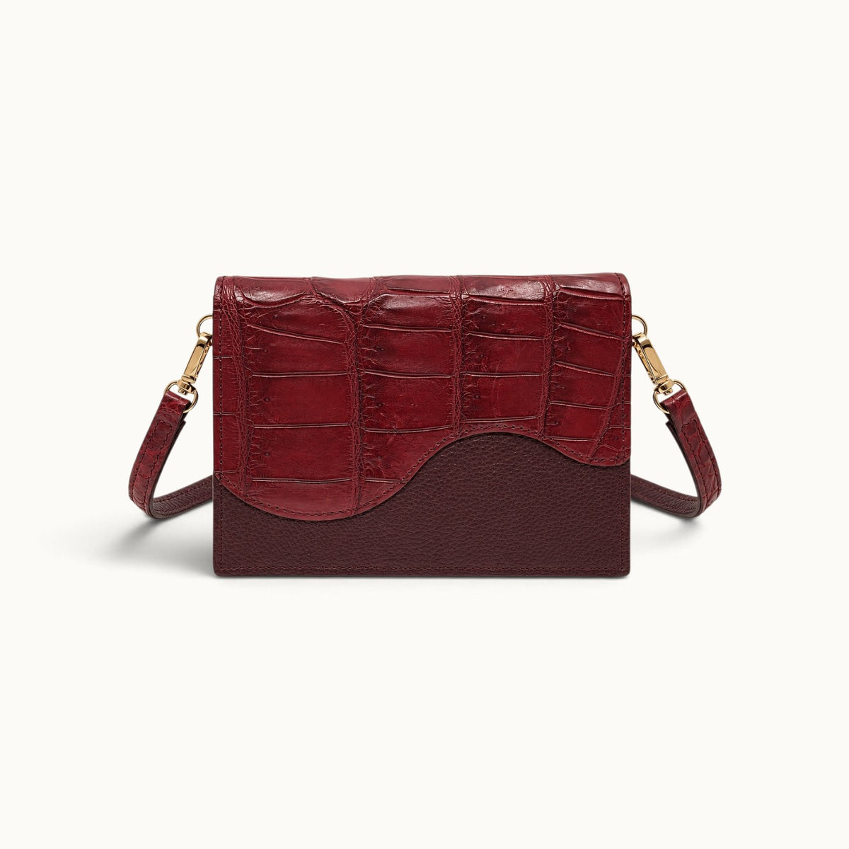 The Berkeley Crocodile Convertible Wallet in Burgundy with genuine Siamese crocodile leather and a removable crocodile leather shoulder strap.