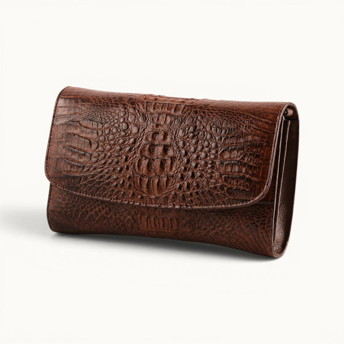 Angled view of The Cavendish genuine caiman crocodile leather shoulder clutch bag in rich brown, showing its structured shape, natural scale pattern, and slim side profile.