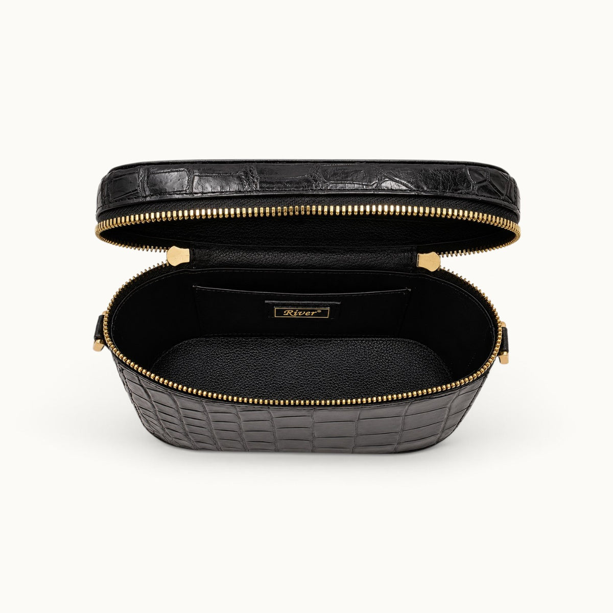 Interior view of The Clarendon Mini Box Bag in Classic Black featuring genuine Siamese crocodile leather, full-grain cow leather interior, double zipper pulls, and structured compartments for cosmetics, travel essentials, and daily carry.