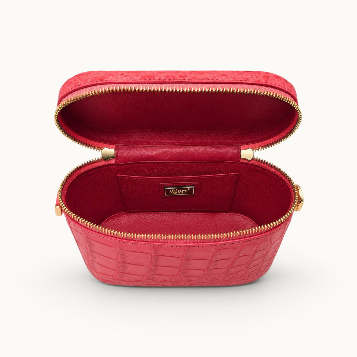 Interior view of The Clarendon Mini Box Bag in Coral Red showcasing genuine Siamese crocodile leather, smooth full-grain cow leather interior, spacious main compartment, and slip pockets inside the luxury mini vanity bag.