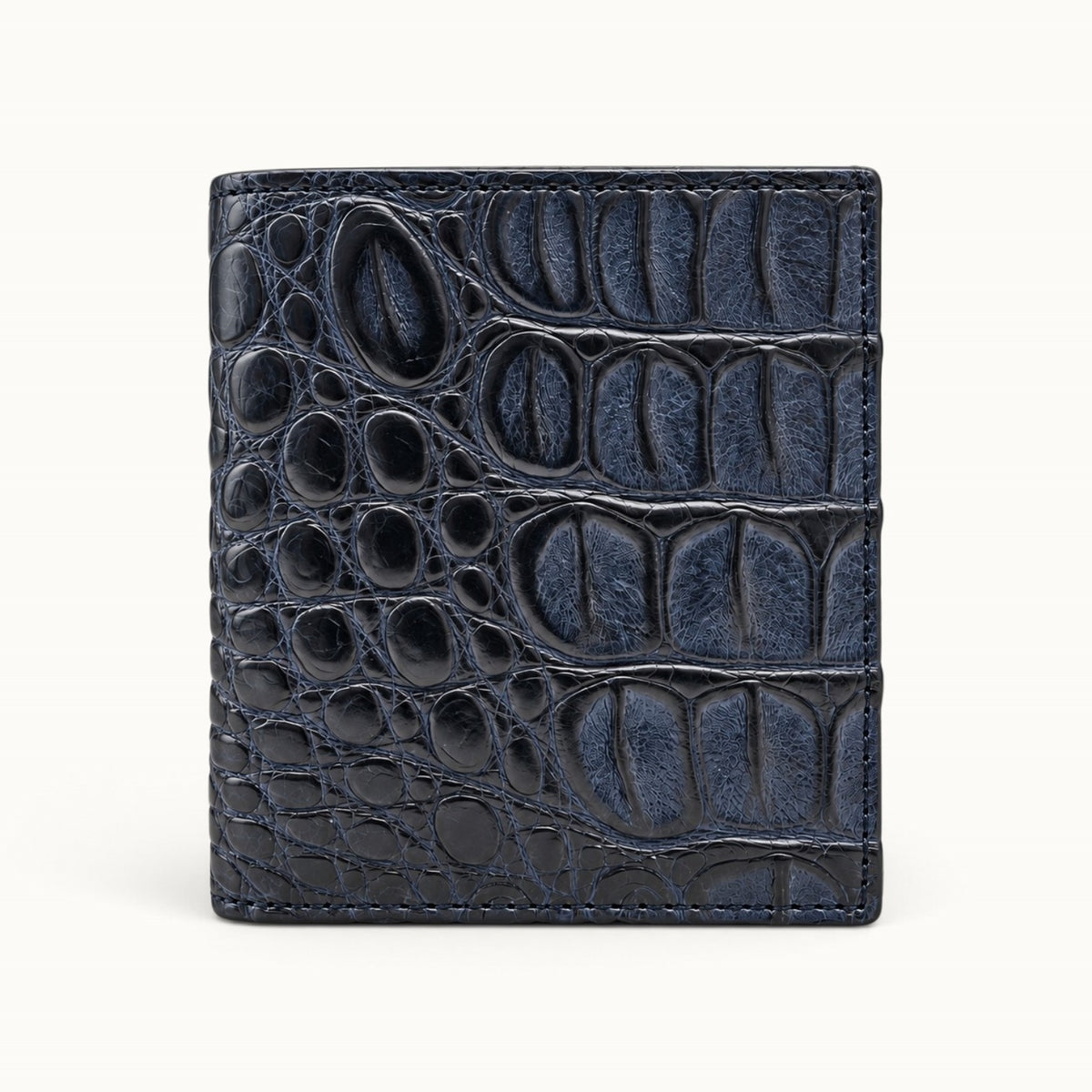 The Compact Crocodile Wallet in Deep Navy genuine Siamese crocodile leather, front view showing the natural scale pattern