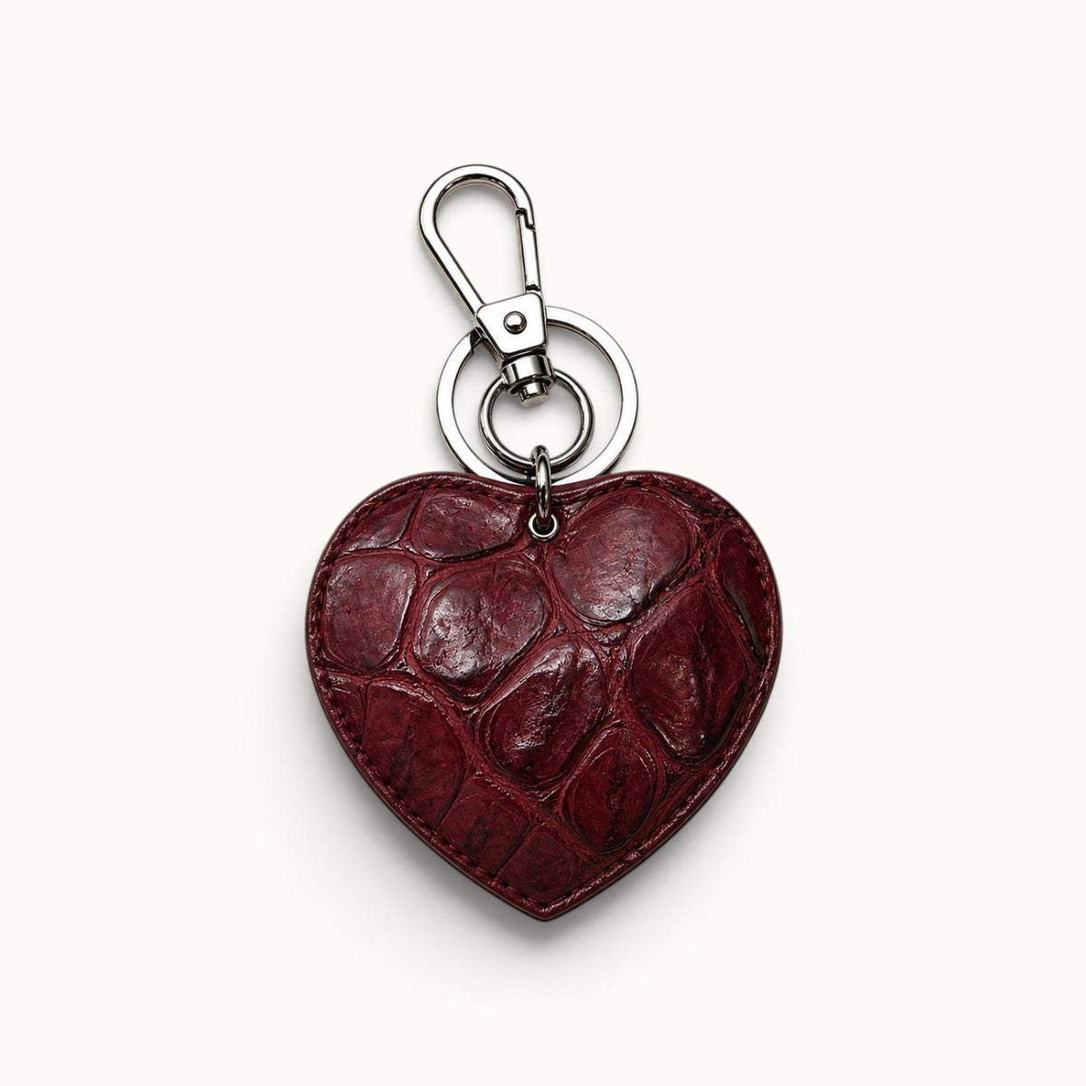 Deep Burgundy Siamese crocodile heart charm with rich natural scale texture and polished silver-tone hardware, designed as a luxury bag and key accessory.