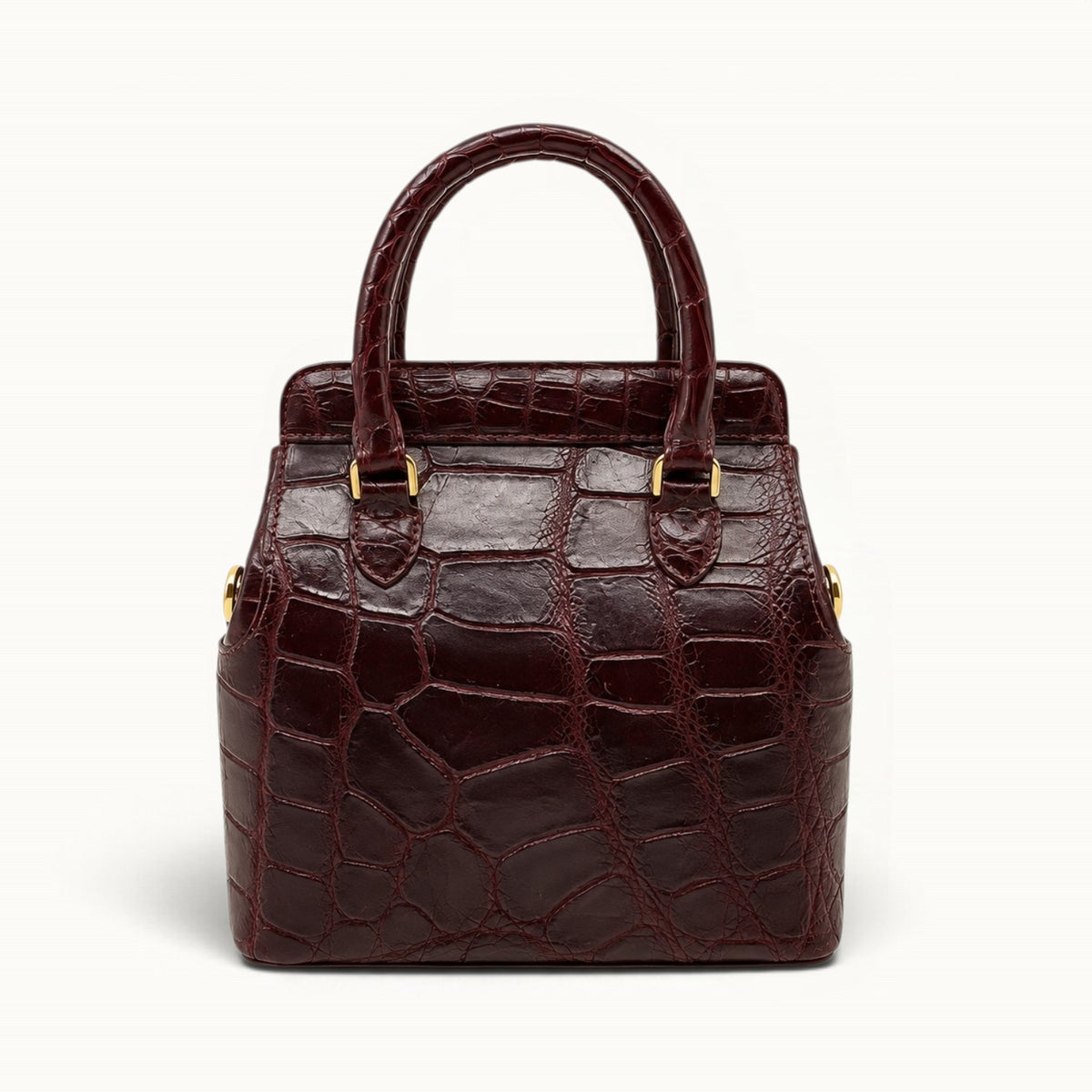 Back view of The Ellery Crocodile Handbag in Bordeaux, featuring natural crocodile scales, rolled leather handles, and gold-tone hardware.