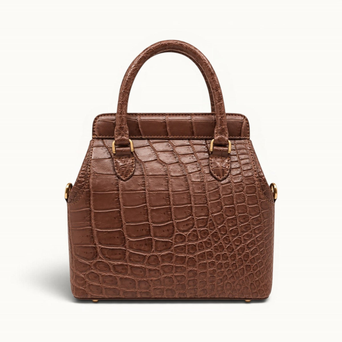 Front view of The Ellery Crocodile Handbag in Cocoa Brown, featuring its structured silhouette, rolled crocodile leather handles, and gold-tone hardware.