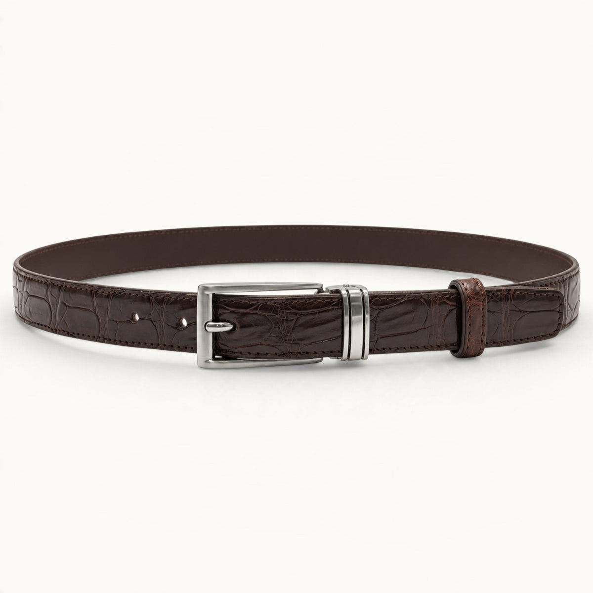 Full front view of The Ellington dark brown crocodile leather belt featuring natural scales, polished silver-tone buckle, and matching leather keeper.