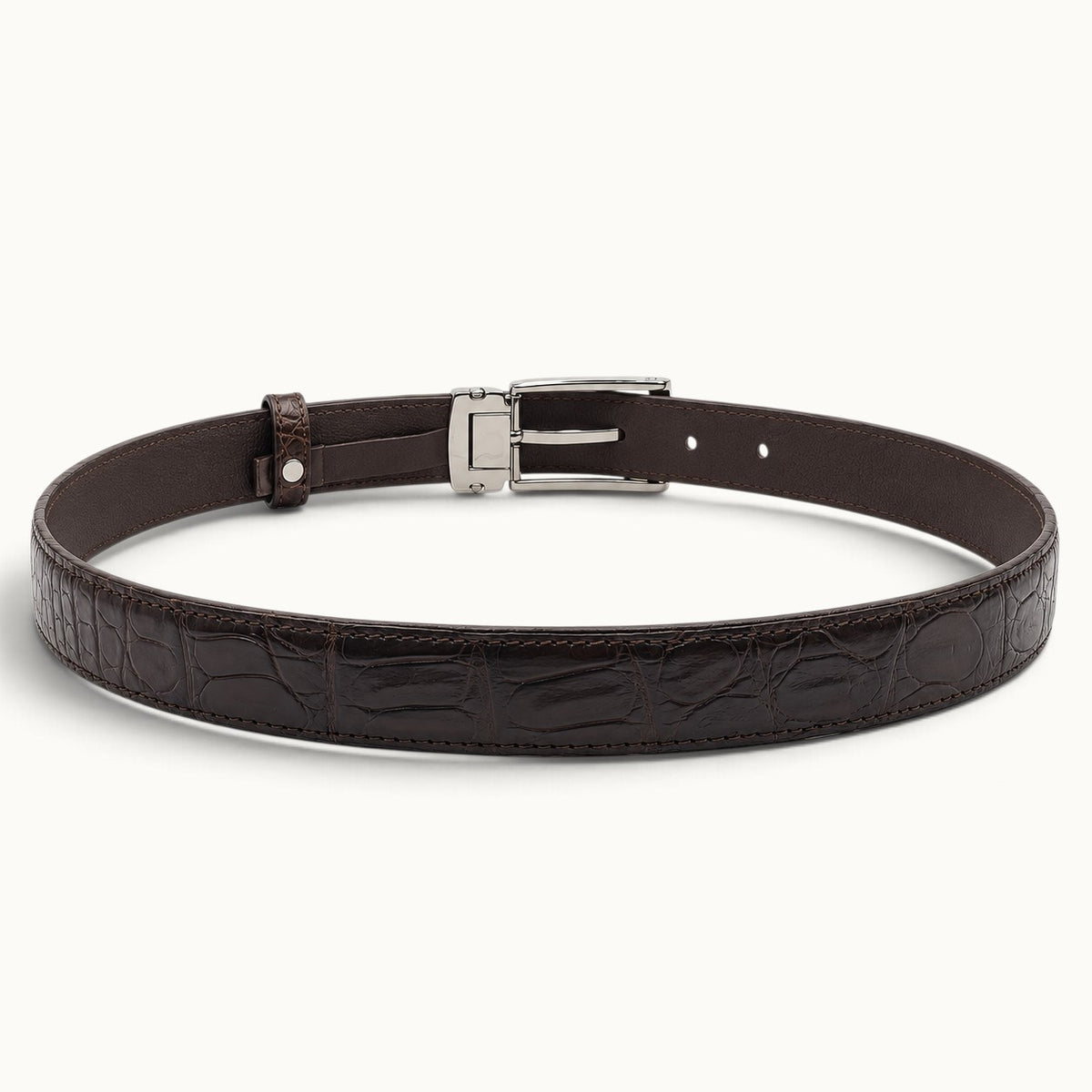 Interior view of The Ellington dark brown crocodile belt showing smooth leather lining, adjustable holes, and silver-tone buckle.