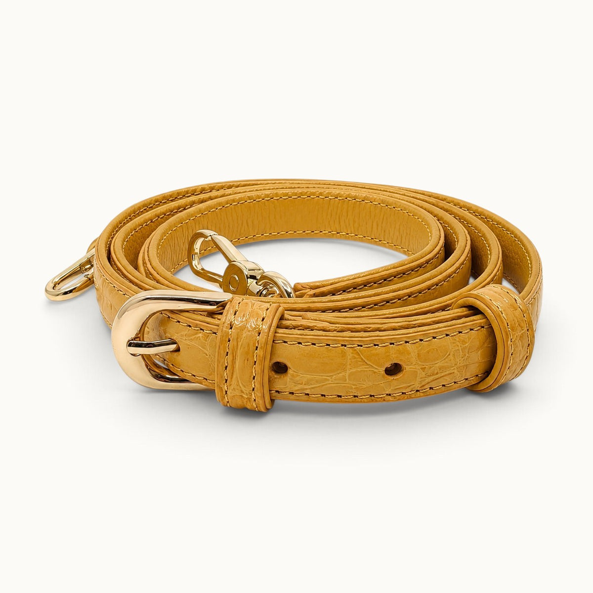 Adjustable detachable crocodile leather shoulder strap for the Grosvenor crossbody bag in Golden Mustard with polished gold-tone hardware.