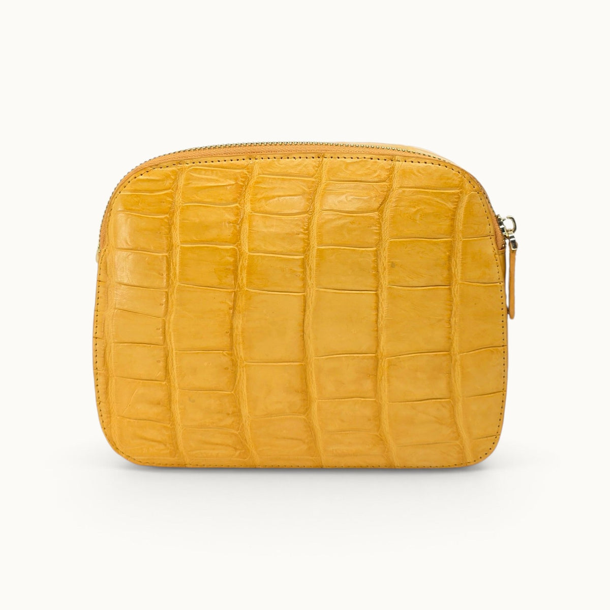 Back view of the Grosvenor Siamese crocodile crossbody bag in Golden Mustard showing the natural scale pattern.