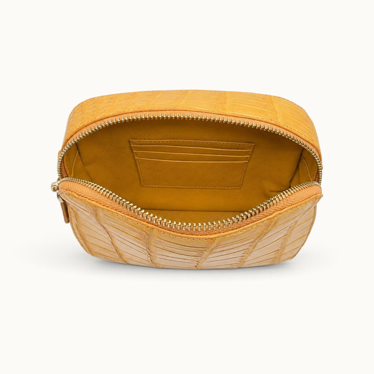 Full-grain cow leather interior of the Grosvenor Siamese crocodile crossbody bag showing three card slots.