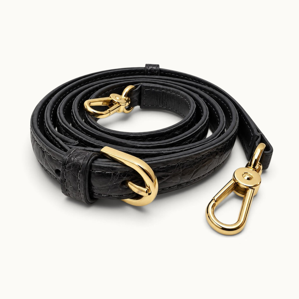 Detachable gunmetal crocodile leather shoulder strap with adjustable buckle and polished gold-tone swivel clasps.