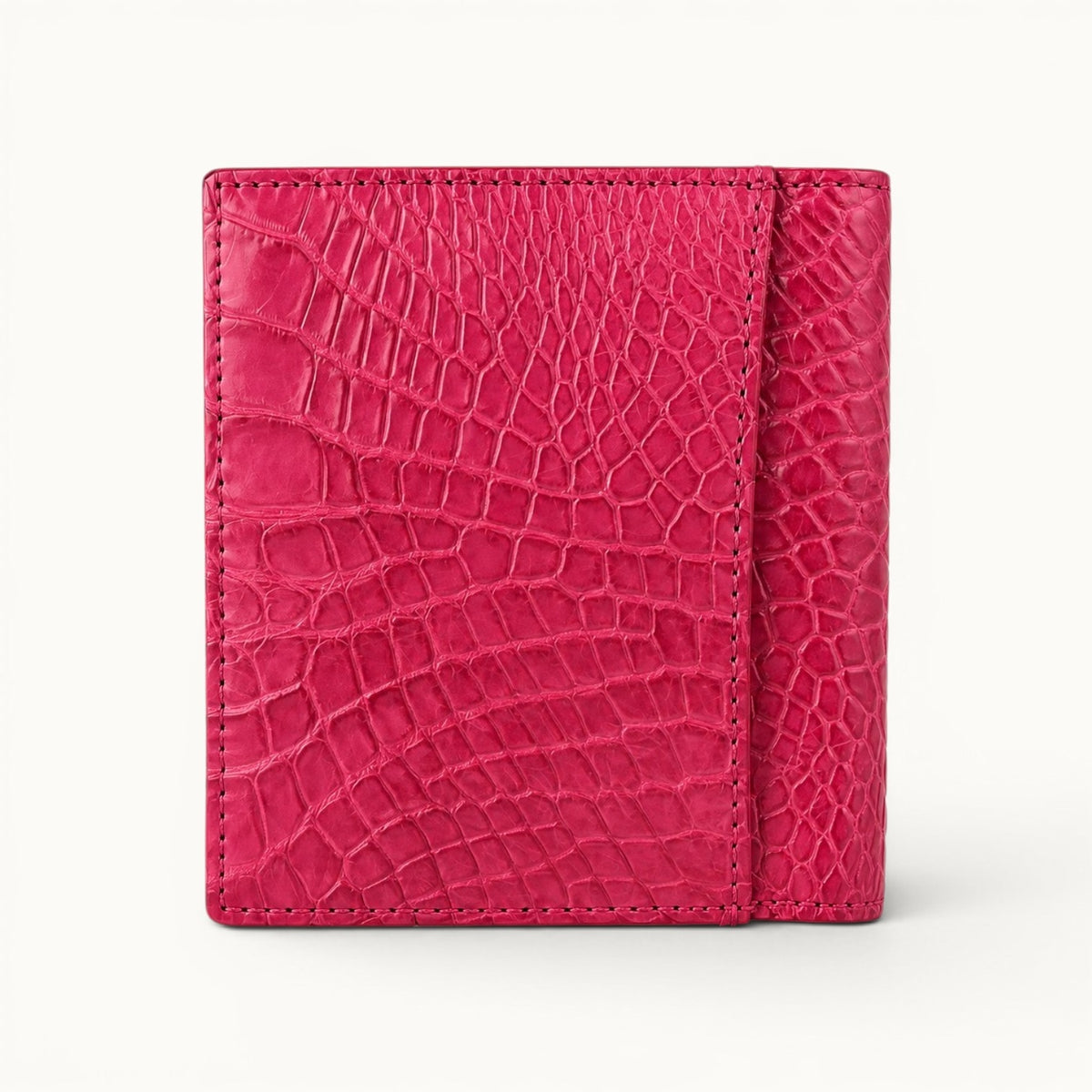Herrington Bright Pink Siamese crocodile trifold wallet shown from the back, featuring a convenient exterior slip pocket and natural scale texture.