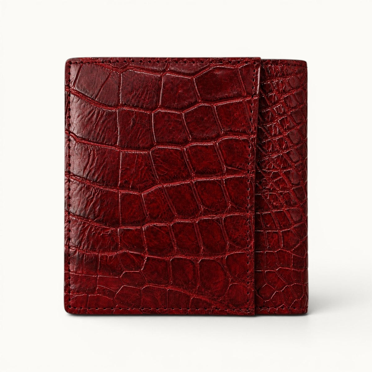 Herrington Cherry Red Siamese crocodile trifold wallet shown from the back, featuring a full-width exterior slip pocket, rich natural scales, and precision stitching.