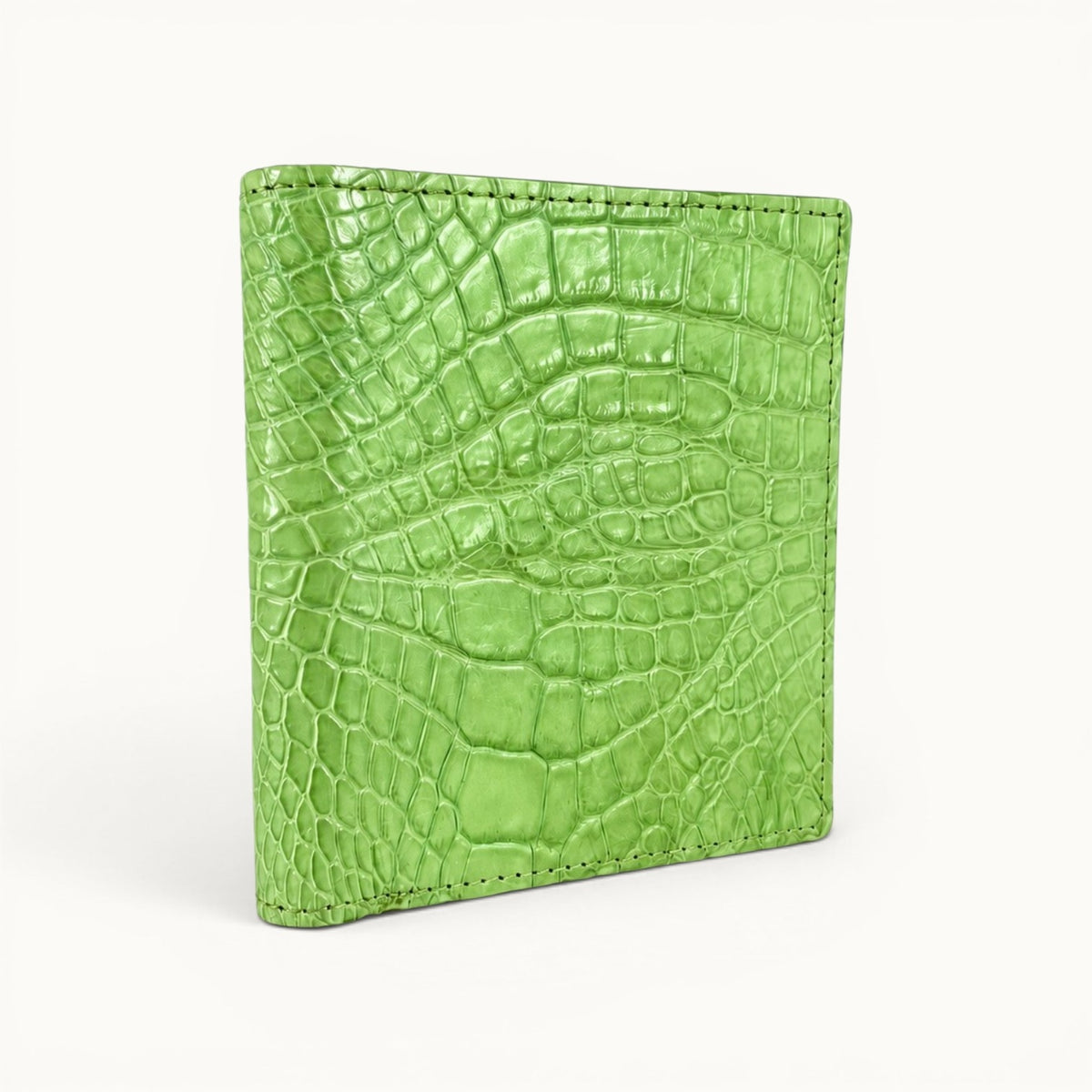 Herrington Lime Green genuine Siamese crocodile trifold wallet shown from an angled view, highlighting its vibrant natural scales, slim profile, and precise edge stitching.