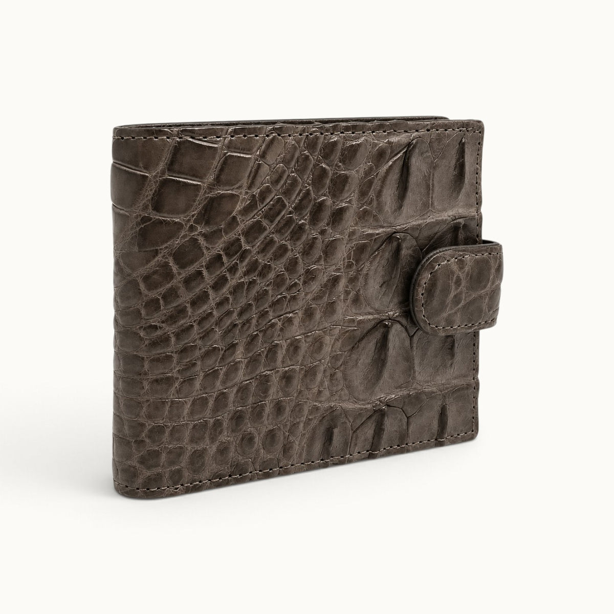 Taupe green Langham crocodile wallet shown at an angle with snap closure and full-belly crocodile exterior