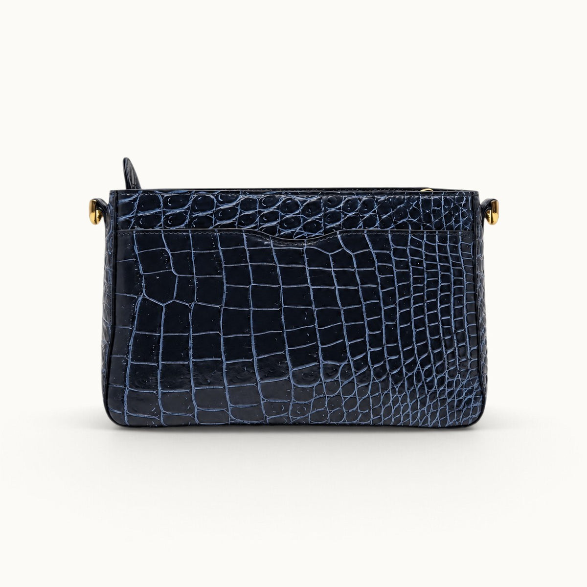Rear view of navy crocodile bag showing full crocodile leather back and exterior slip pocket