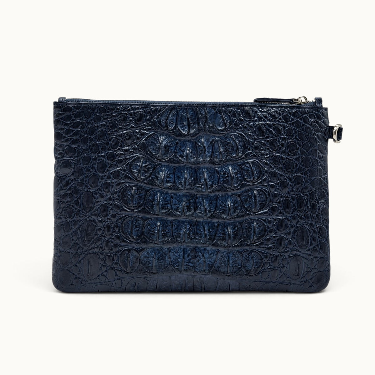 Navy exotic leather clutch bag showing natural crocodile scales across the reverse panel