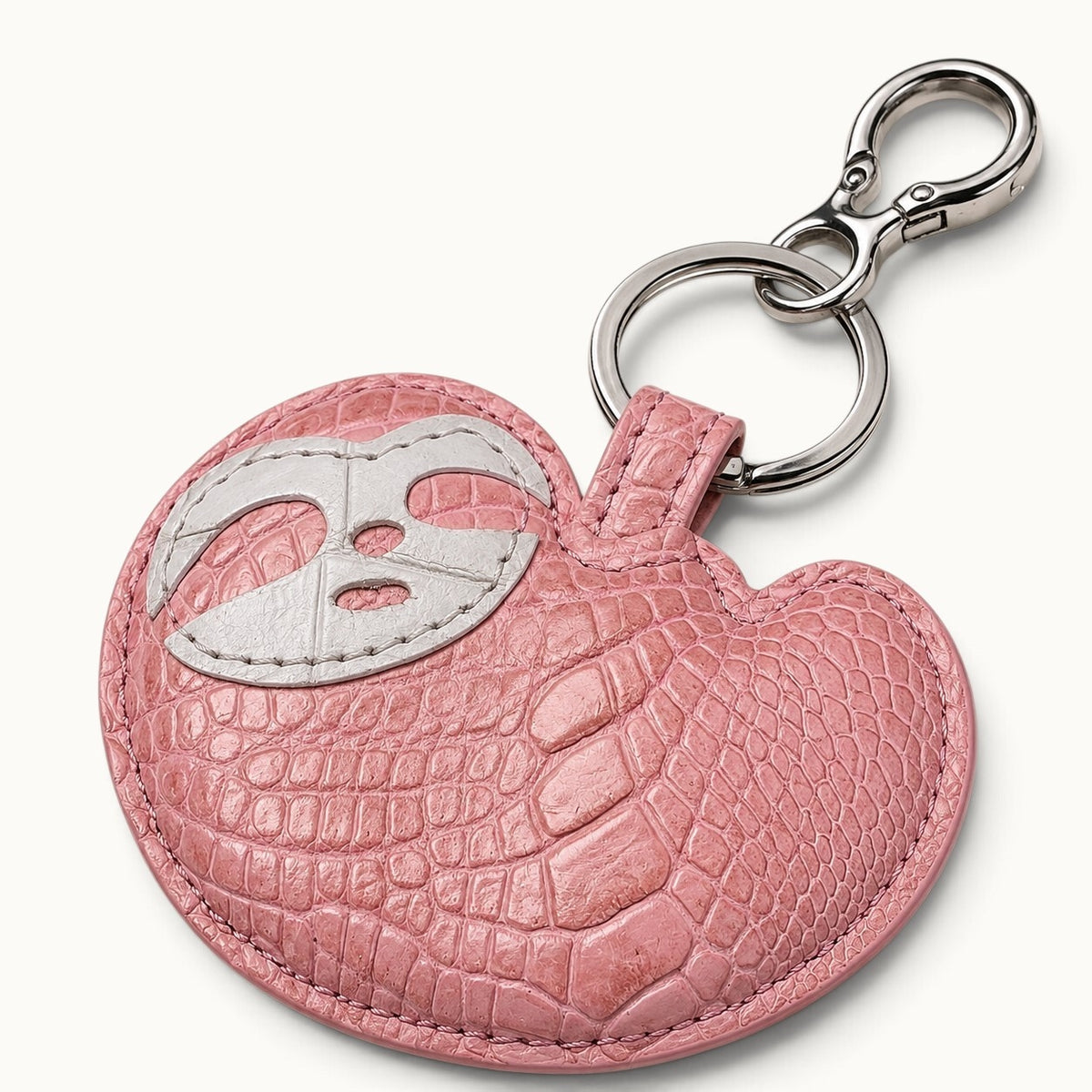 Blush Pink Crocodile Palette Bag Charm shown at an angle with detailed crocodile scales, white mask motif, and silver-tone hardware