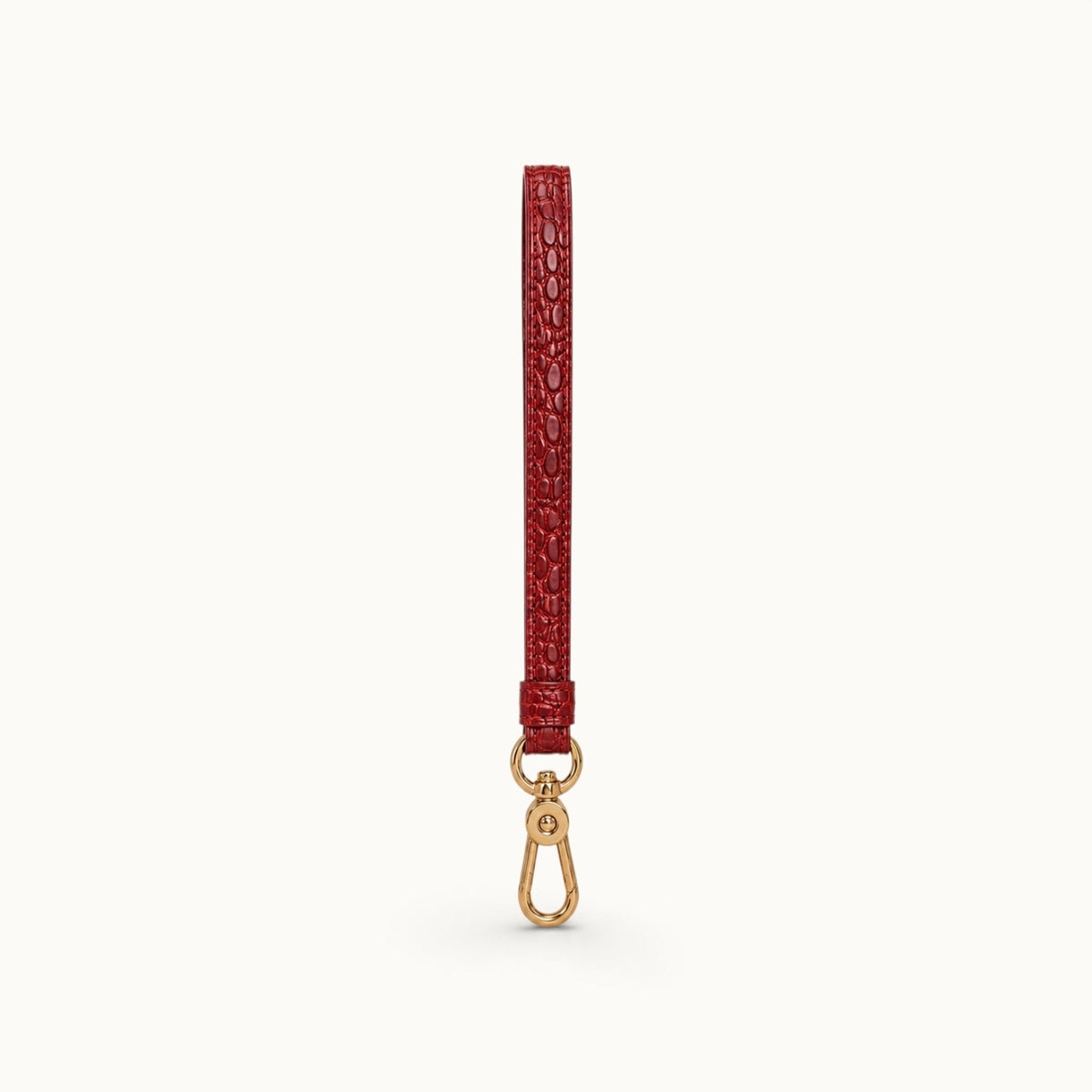 Full-length front view of the Burgundy Red Stanhope crocodile wrist strap with polished gold-tone clasp.