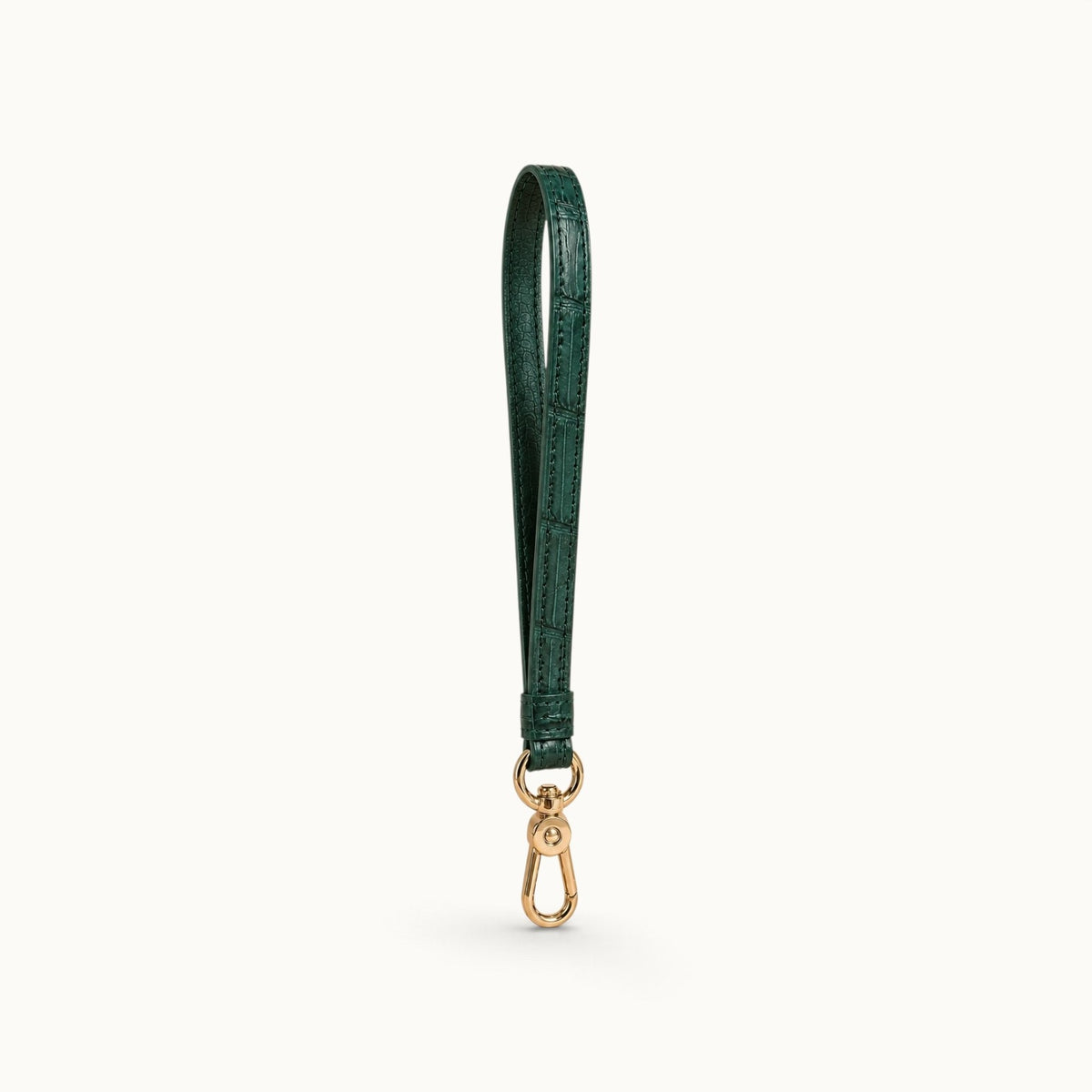 Angled view of the Emerald Green Stanhope crocodile wrist strap showing the crocodile texture, cow leather interior, and gold-tone clasp.
