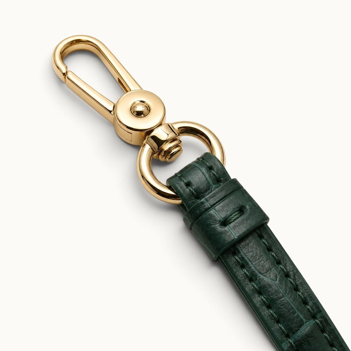 Close-up of the Emerald Green Stanhope crocodile wrist strap with polished gold-tone swivel clasp, ring hardware, and detailed stitching.