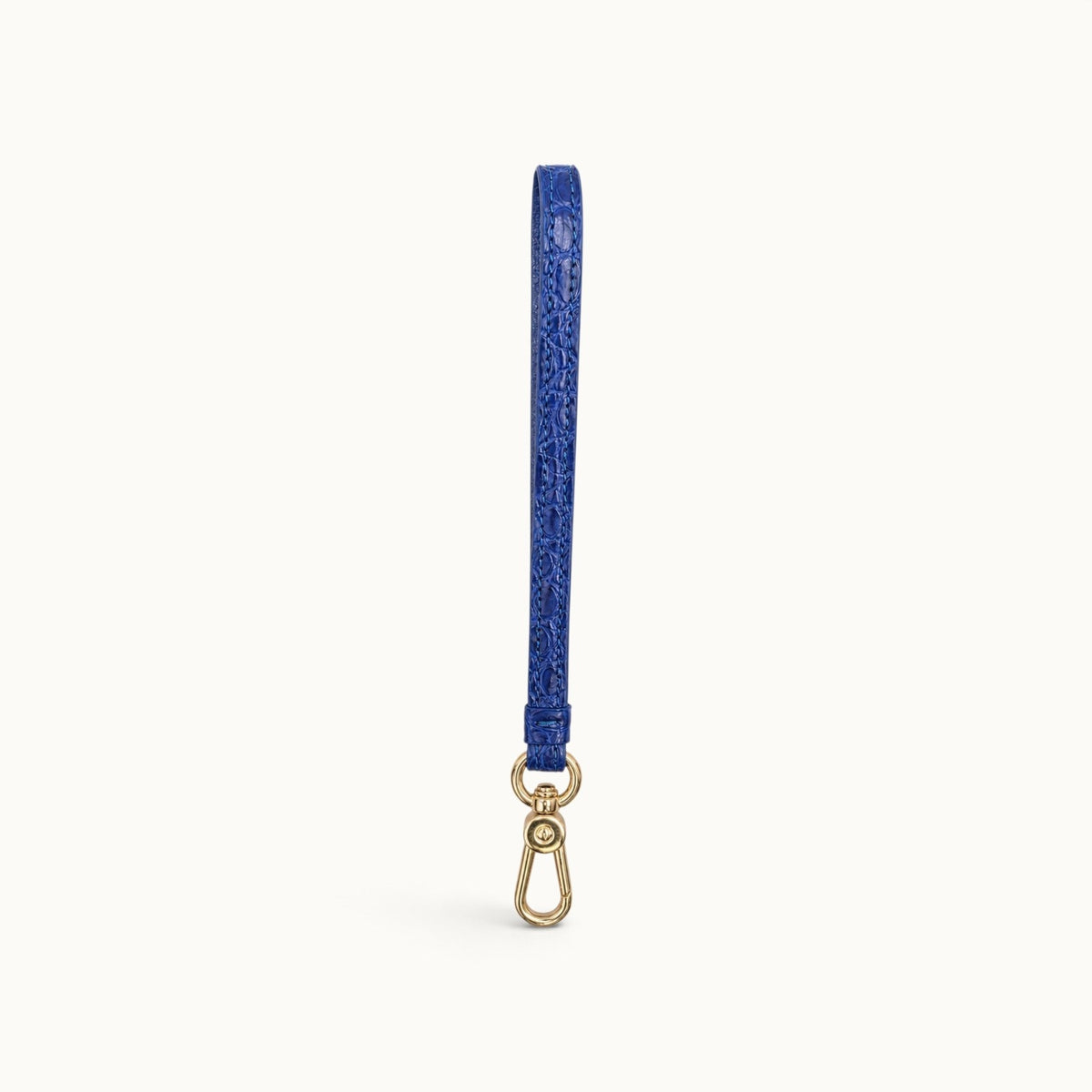 Full-length front view of the Royal Blue Stanhope crocodile wrist strap with gold-tone clasp.