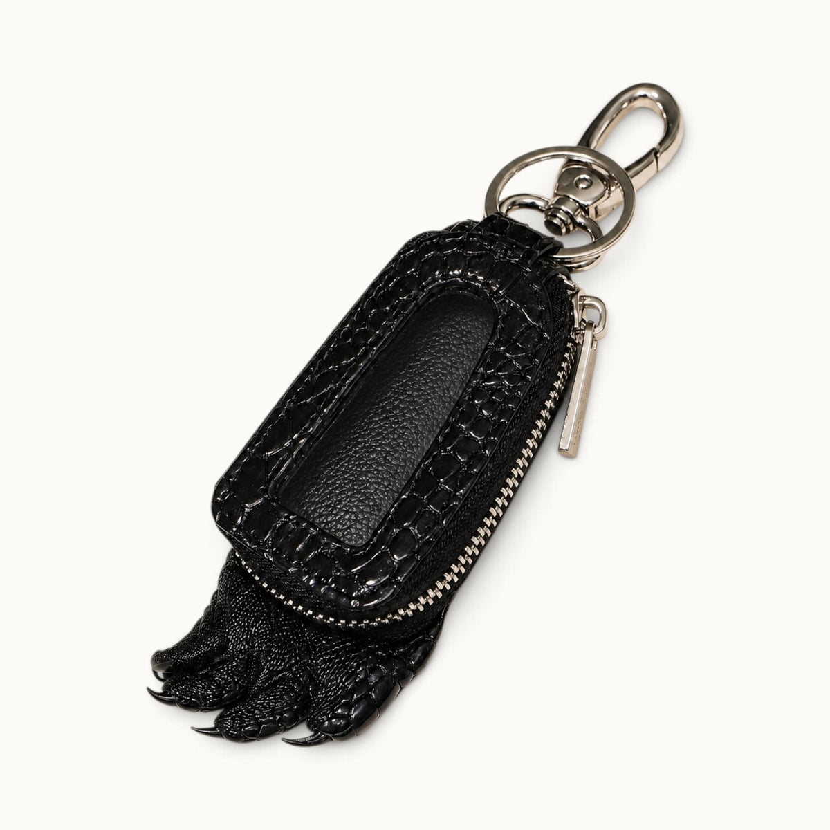 Black Siamensis crocodile leather car key case shown at a three-quarter angle with clear front window, YKK zipper, silver-tone hardware, and sculpted claw detail.