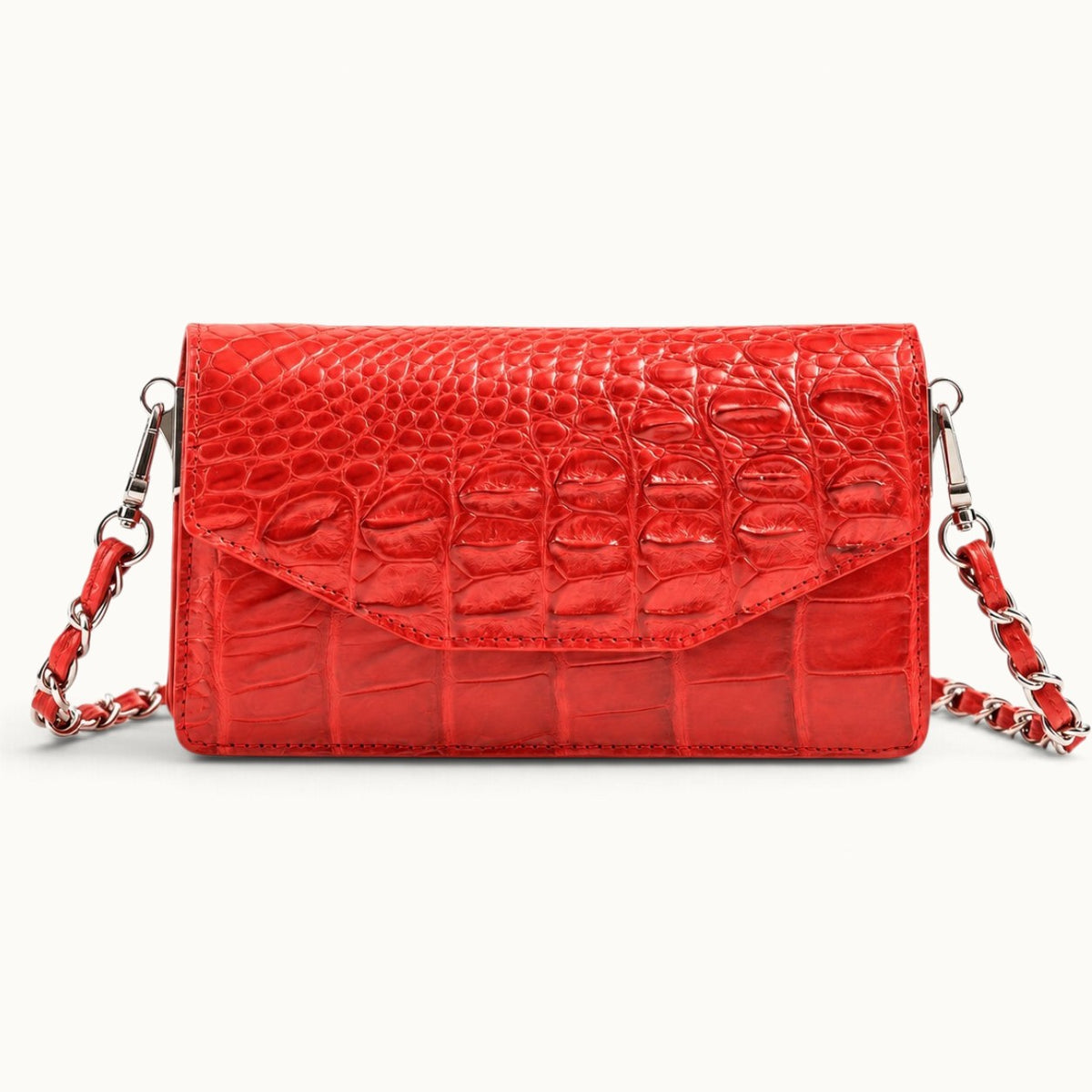 The Chelsea red Siamese crocodile leather shoulder bag, front view with envelope flap and silver-tone chain strap.