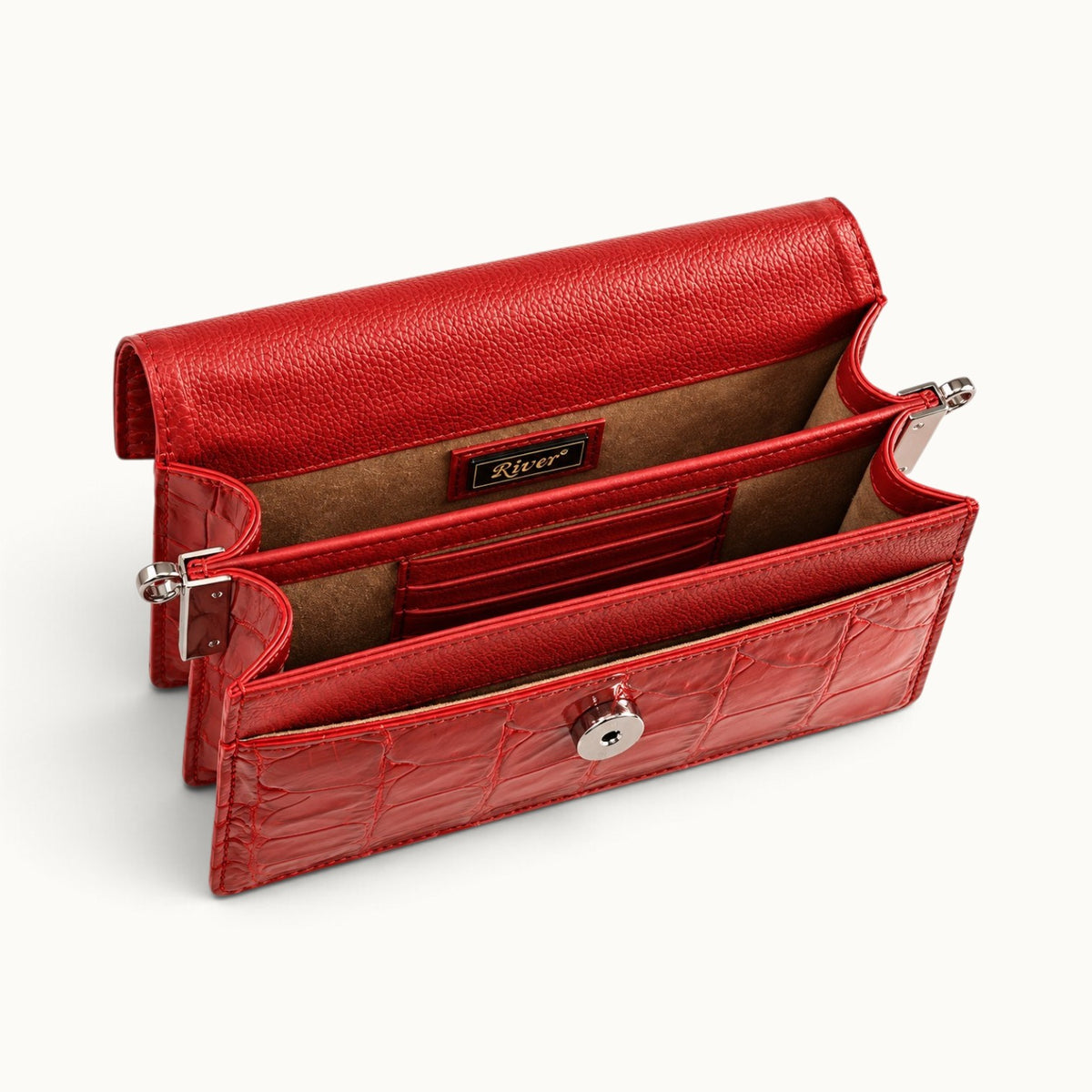 Open interior of The Chelsea red Siamese crocodile leather shoulder bag showing two compartments, six card slots, suede lining, and River branding.