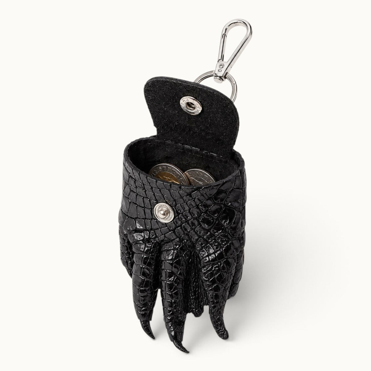 The Claw Crocodile Coin Pouch open with coins inside, showing the raw leather interior and snap closure
