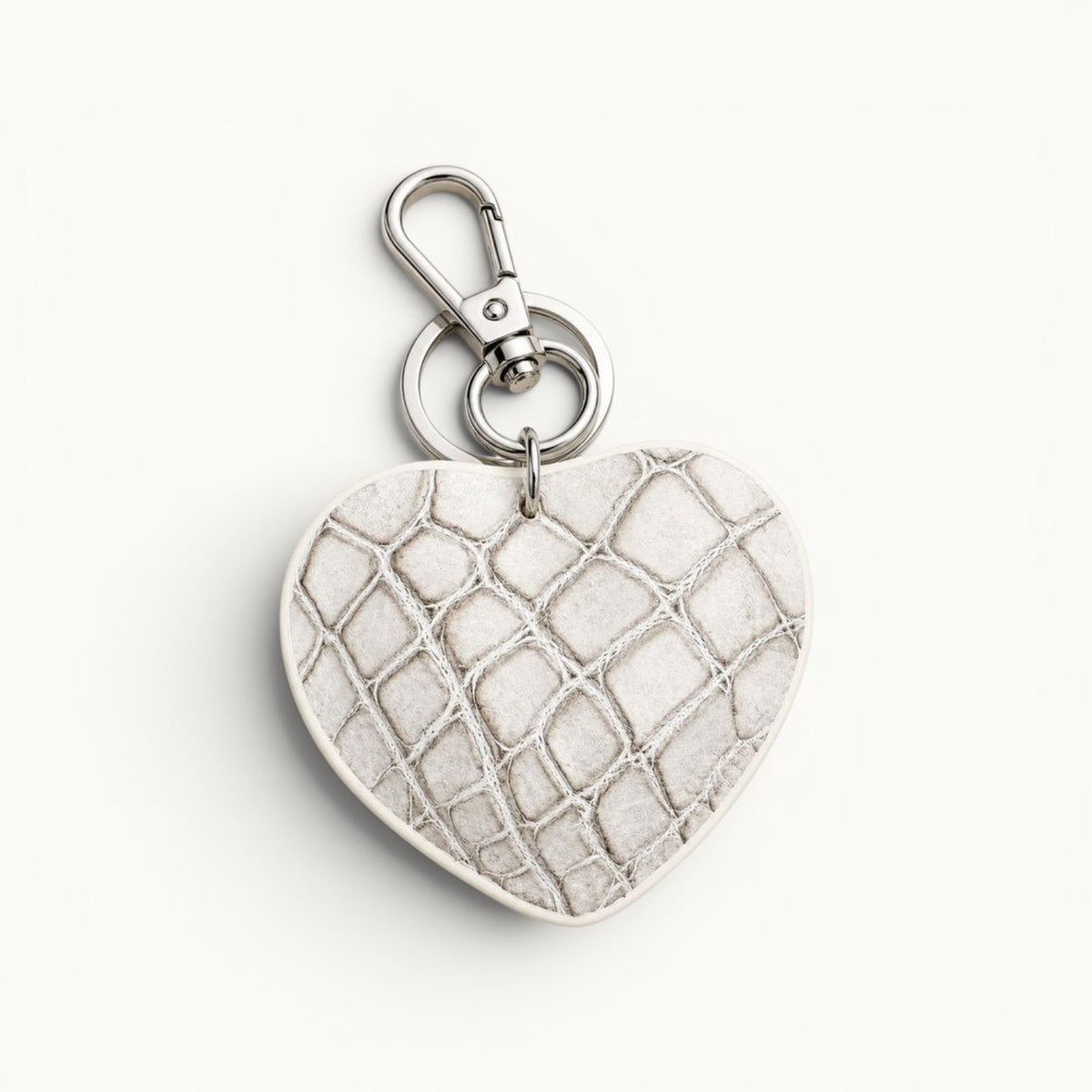 The Heart Key Charm in ivory Siamese crocodile leather with polished silver-tone hardware.
