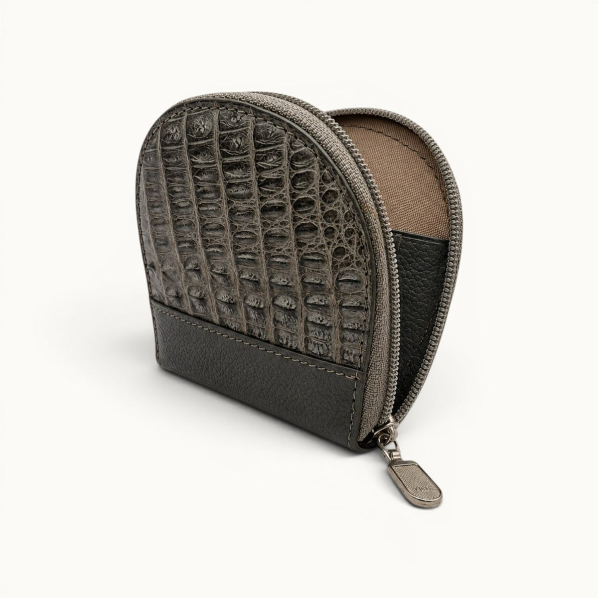 Open view of The Sovereign taupe green crocodile leather zippered change holder showing its compact interior compartment, textured lining, and silver-tone closure.