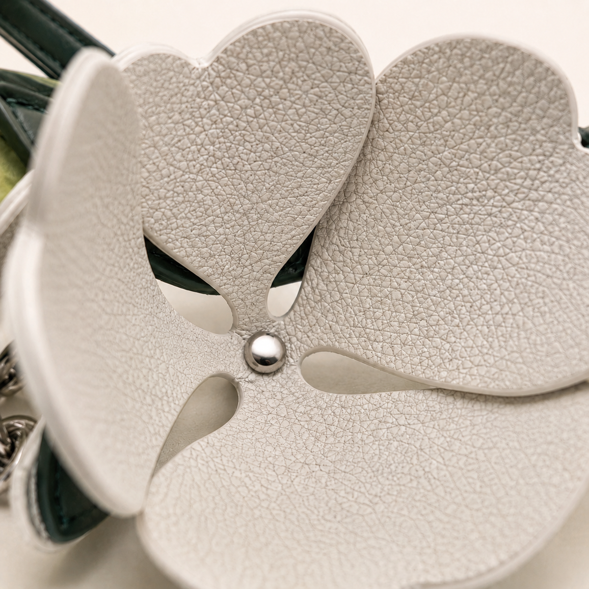 Interior view of the Stone Ivory Valencia crocodile flower charm showing pebbled cow leather and petal construction
