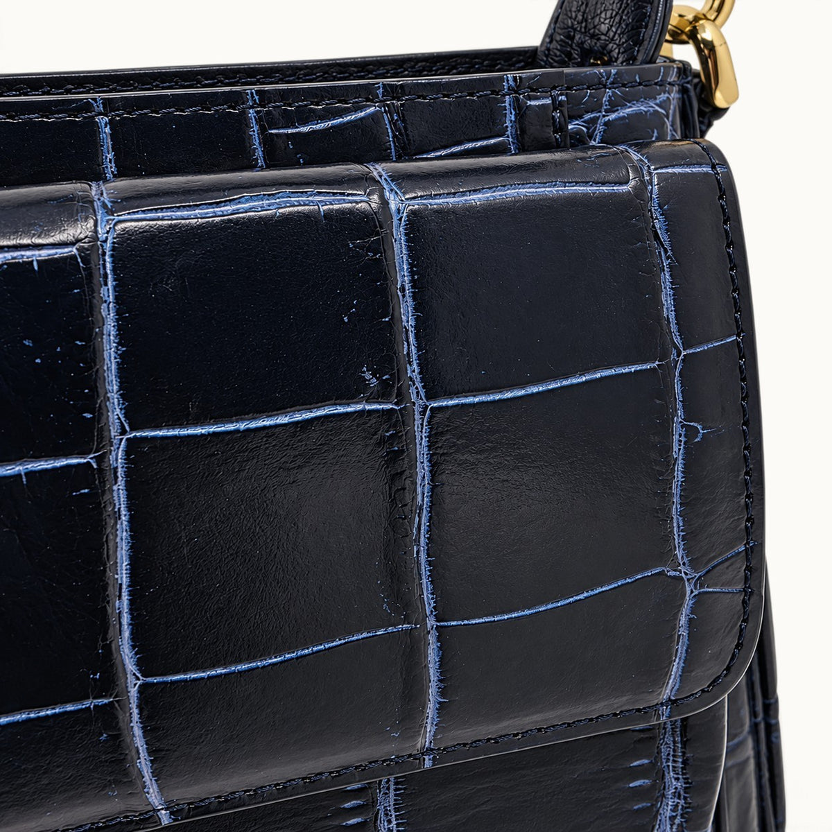 Close-up of two-tone blue Siamese crocodile leather scales and stitching on The Alderley Crocodile Shoulder Bag