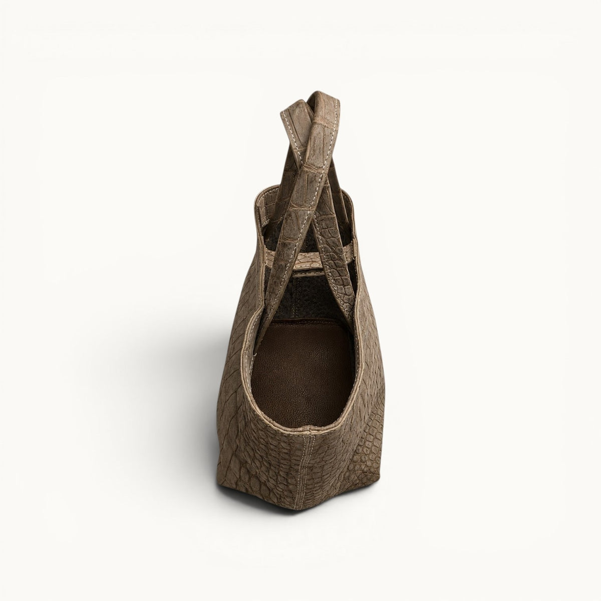 Interior view of The Atelier Tote handcrafted from genuine Porosus crocodile leather, showcasing the unlined construction and premium full-grain leather base.