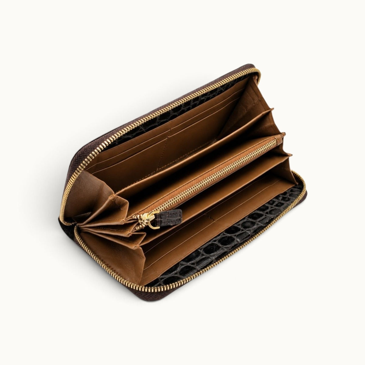 Angled interior view of the Belvedere Siamese crocodile zip-around wallet with lambskin lining, divided compartments, card slots, and central zip pocket