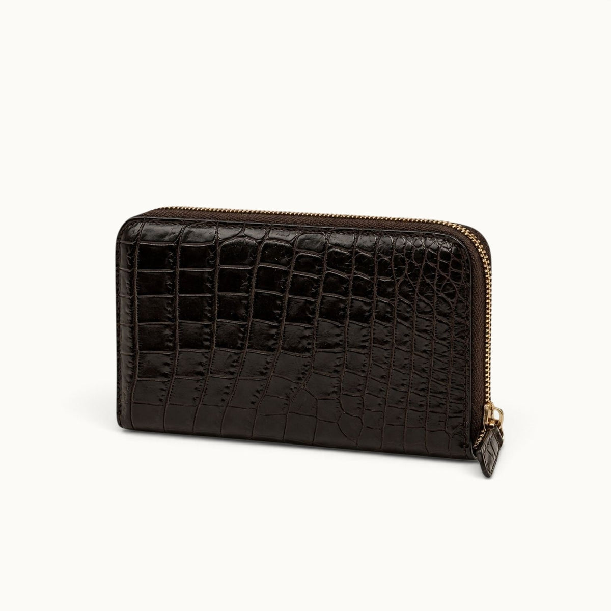 Angled view of the Belvedere Siamese crocodile zip-around wallet in Nicotine Brown with natural scale pattern and gold-tone hardware