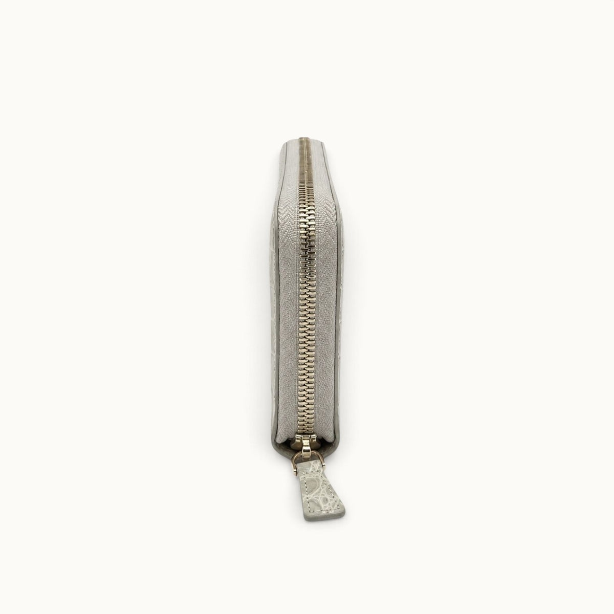 Side view of the Belvedere Siamese crocodile zip-around wallet in Stone Gray showing its slim profile and zip-around closure