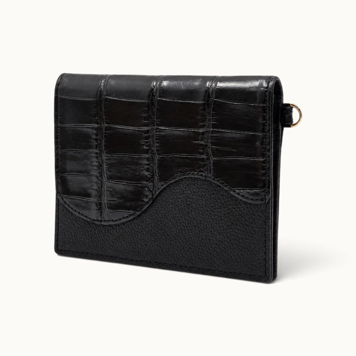 Angle view of The Berkeley Convertible Wallet in Black, crafted from genuine Siamese crocodile leather with a slim pebbled calf leather profile.
