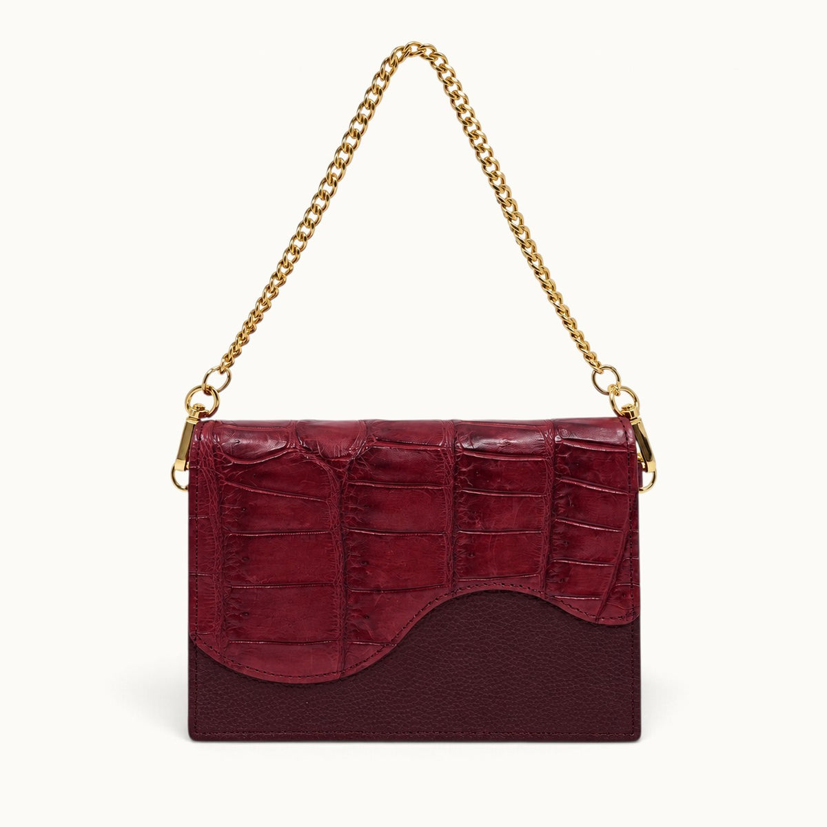 The Berkeley Crocodile Convertible Wallet in Burgundy with genuine Siamese crocodile leather, pebbled calf leather, and removable gold-tone chain.