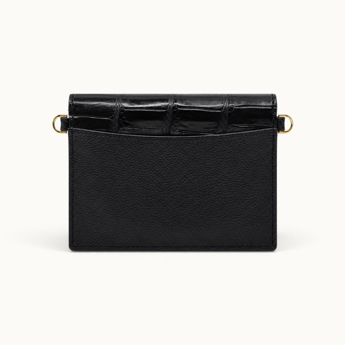 Back view of The Berkeley Crocodile Convertible Wallet in Classic Black with a slim exterior slip pocket, soft pebbled calf leather, genuine Siamese crocodile trim, and gold-tone D-rings.