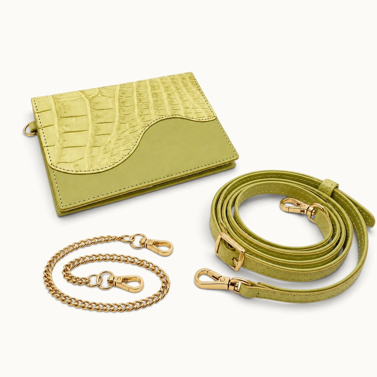 The Berkeley Crocodile Convertible Wallet in Lime Green shown with its removable gold-tone chain and adjustable crocodile leather shoulder strap.
