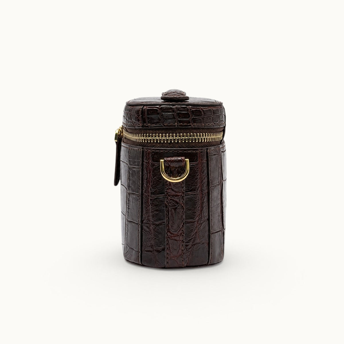 Side view of a Bordeaux crocodile crossbody mini bag with gold-tone D-ring, compact depth and structured construction.