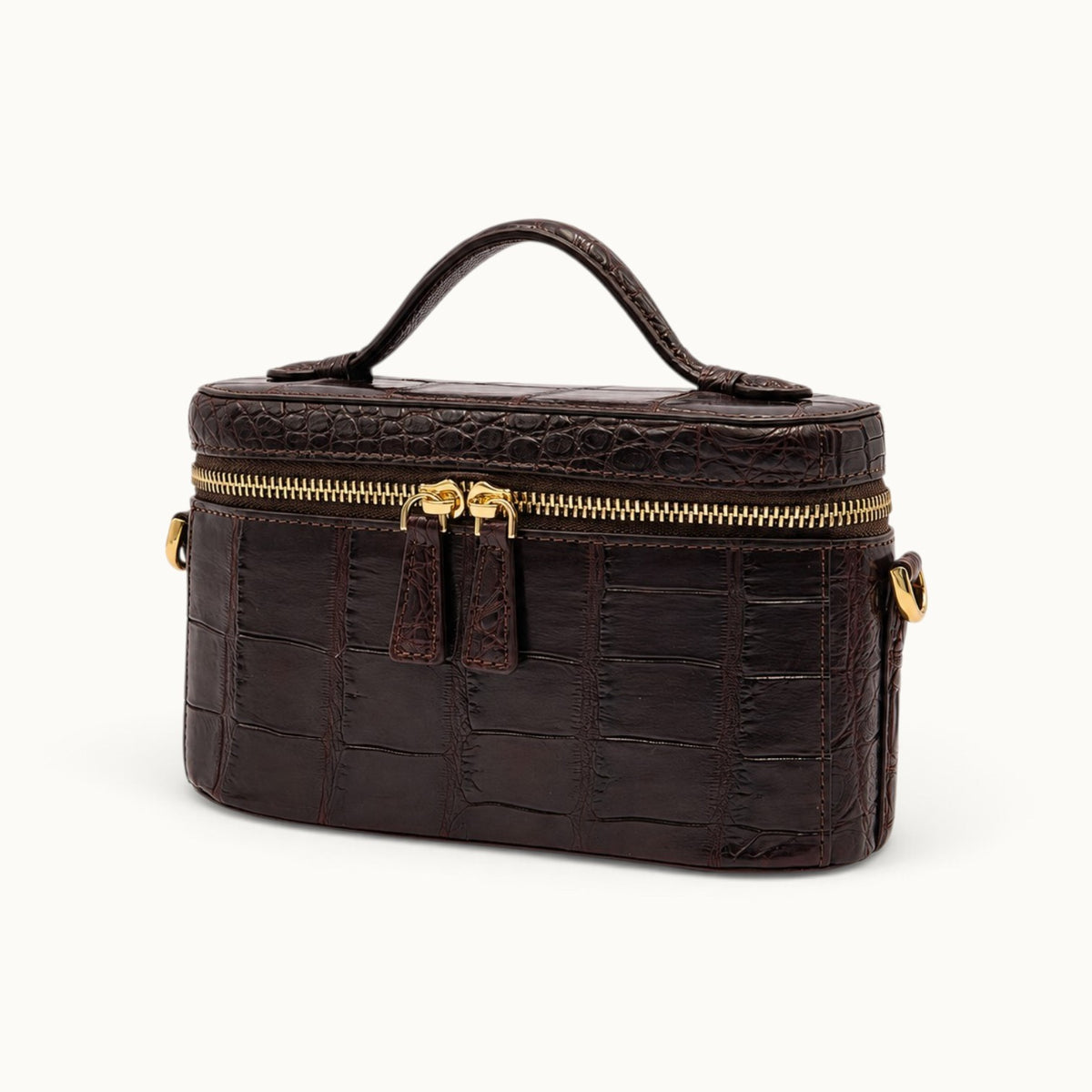 Three-quarter angle of a Bordeaux luxury crocodile evening bag with structured vanity silhouette and elegant top handle.